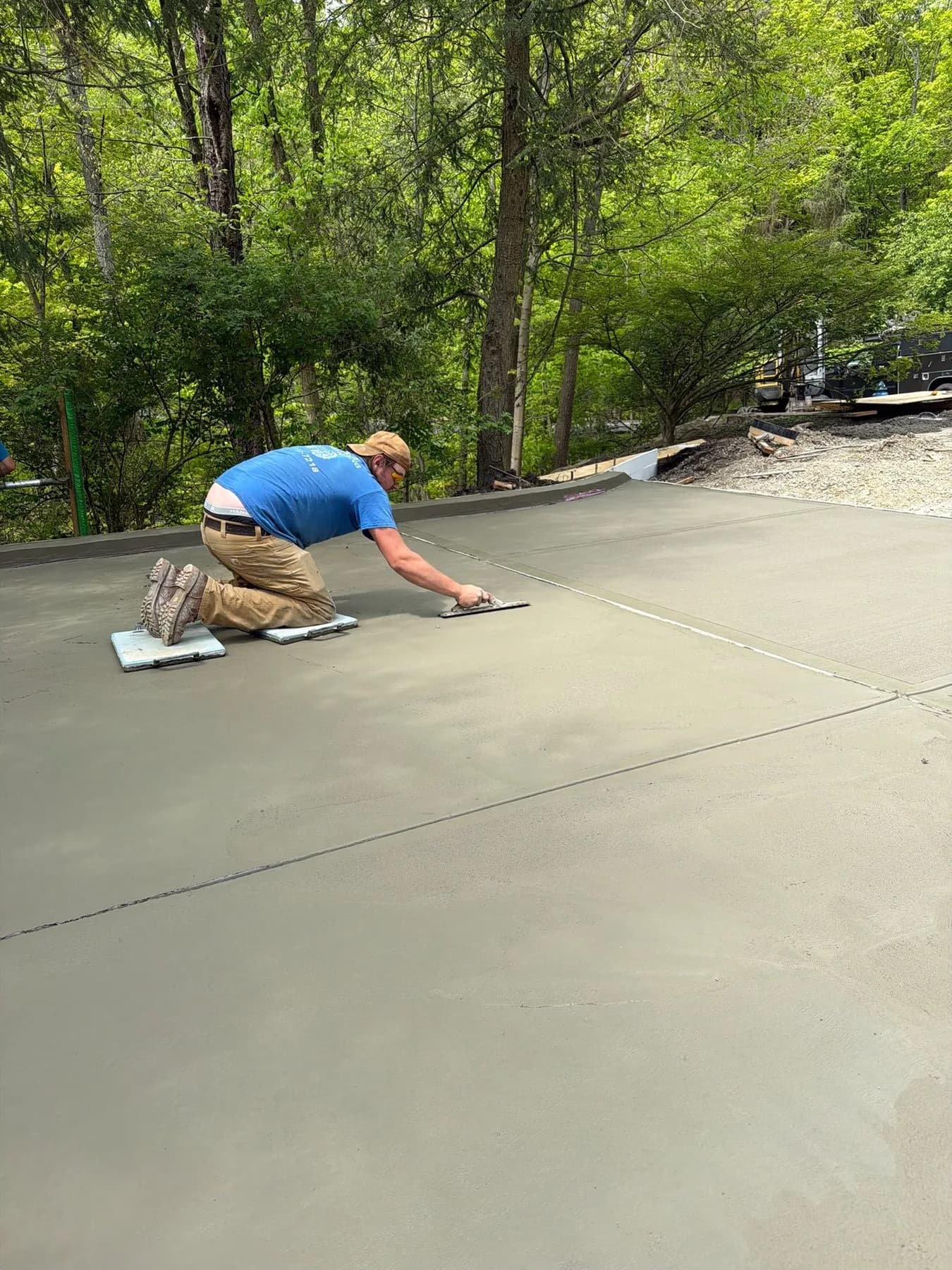 Corwin crew hand-finishing a poured concrete driveway